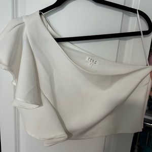 One shoulder white top
